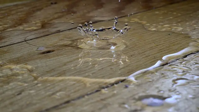 Water pooling on weathered wood floor planks